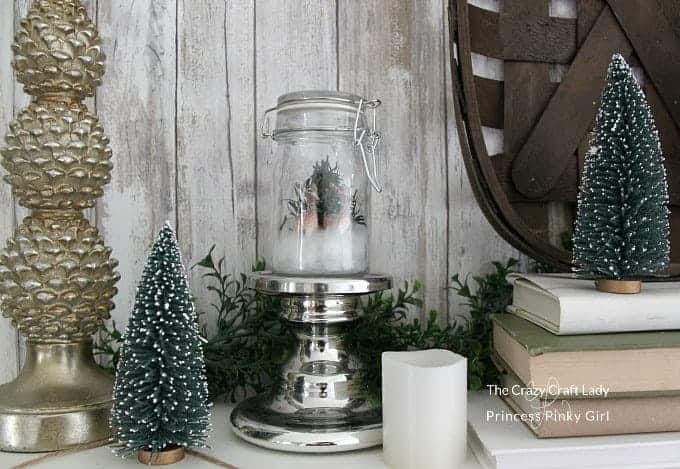 Follow this tutorial to make a DIY Snow Globe! This mini glass jar snow globe is a mason jar winter scene is perfect for Christmas and winter decor.