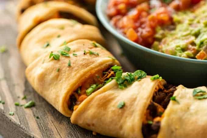 taco ring close up with salsa and guacamole in background