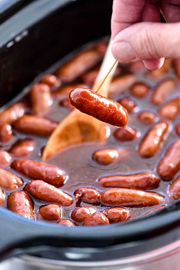 A slow cooker with mini hotdogs in sauce