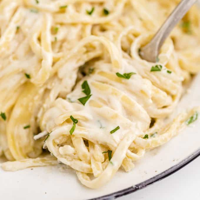 Copycat Olive Garden Alfredo Sauce square on fork