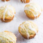 A batch of Lemon Poppy Seed Muffins topped with a lemon glaze