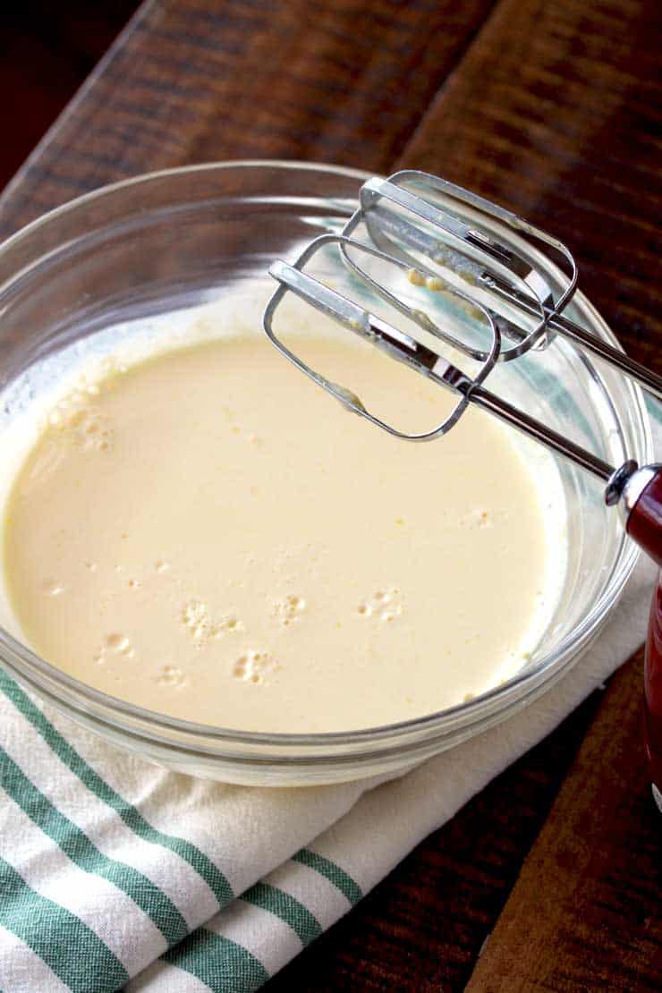 A bowl of banana cream pie dip with a blender in a glass bowl