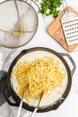 toss pasta with alfredo sauce