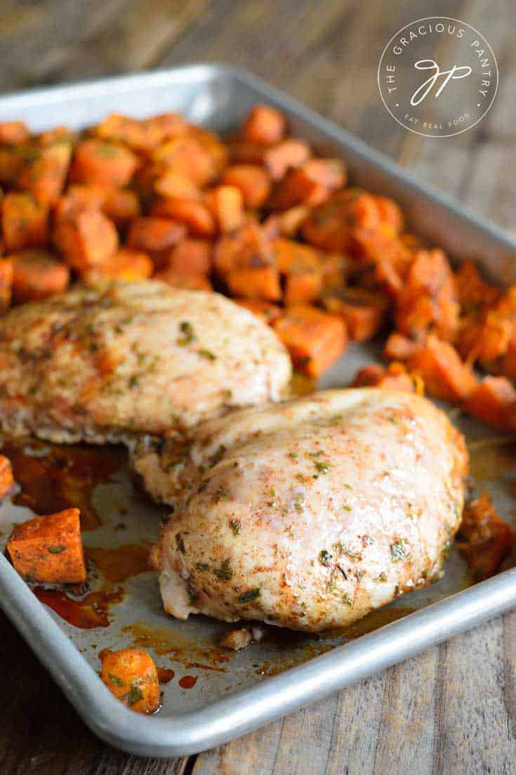 A baking pan with carrots and chicken