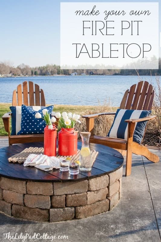 A fire pit with a DIY table top and a lake behind it