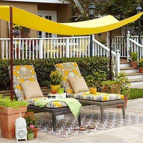 A DIY backyard shade that you can make on your own covering two lounge chairs