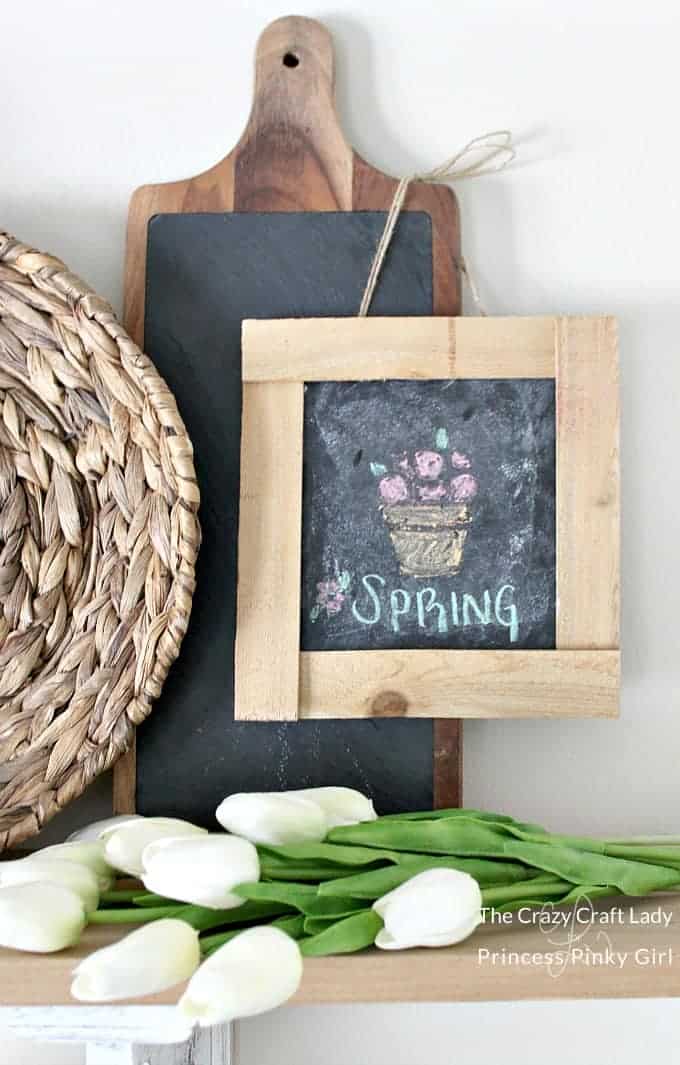 A chalkboard frame made by hand with the word spring written on it