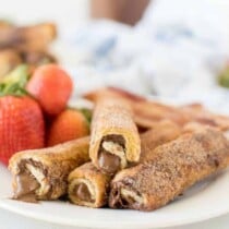 Nutella French Toast Roll Ups Square on a plate with strawberries