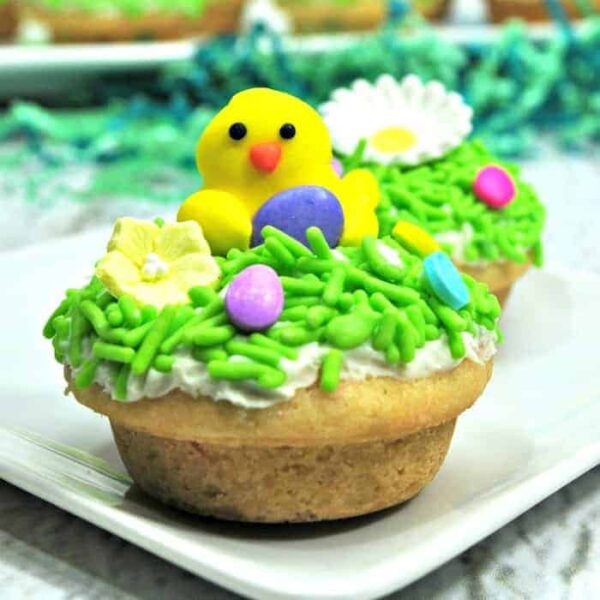 An Easter cookie Cobb with a mini decorative chick on top and flowers