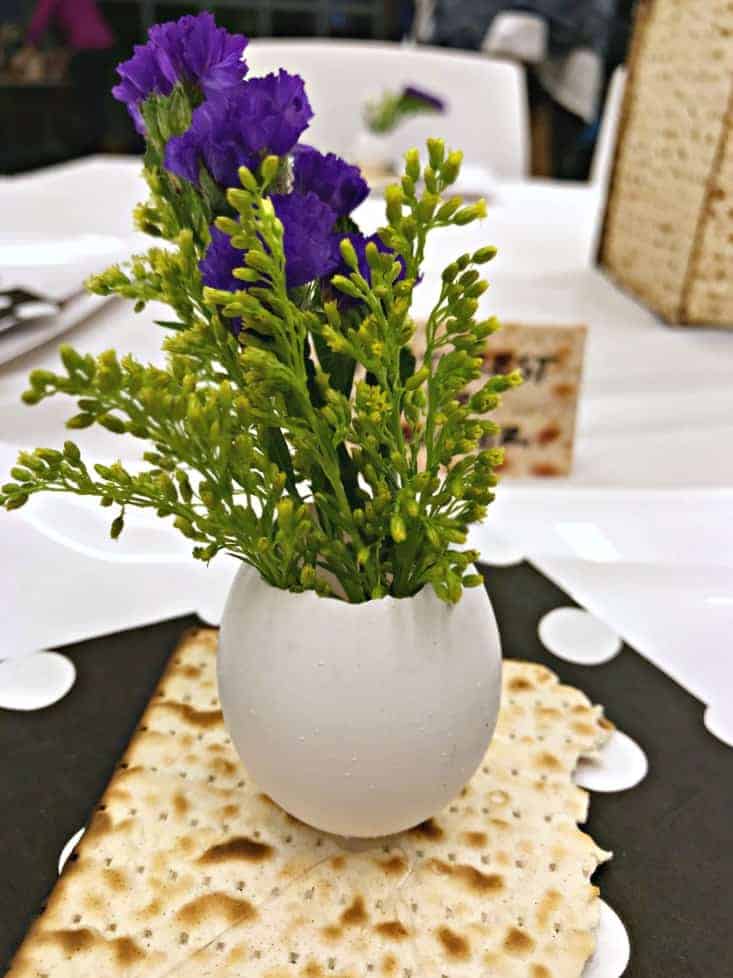 eggshell bud vase with purple flowers