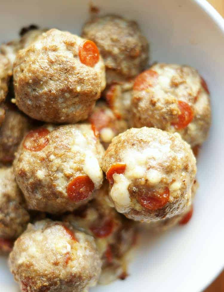 Roll the meatballs and bake. The cheese will ooze from the meatball