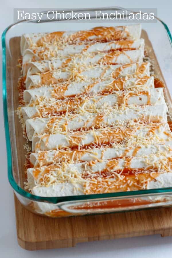 Chicken enchiladas in a glass dish before they are cooked