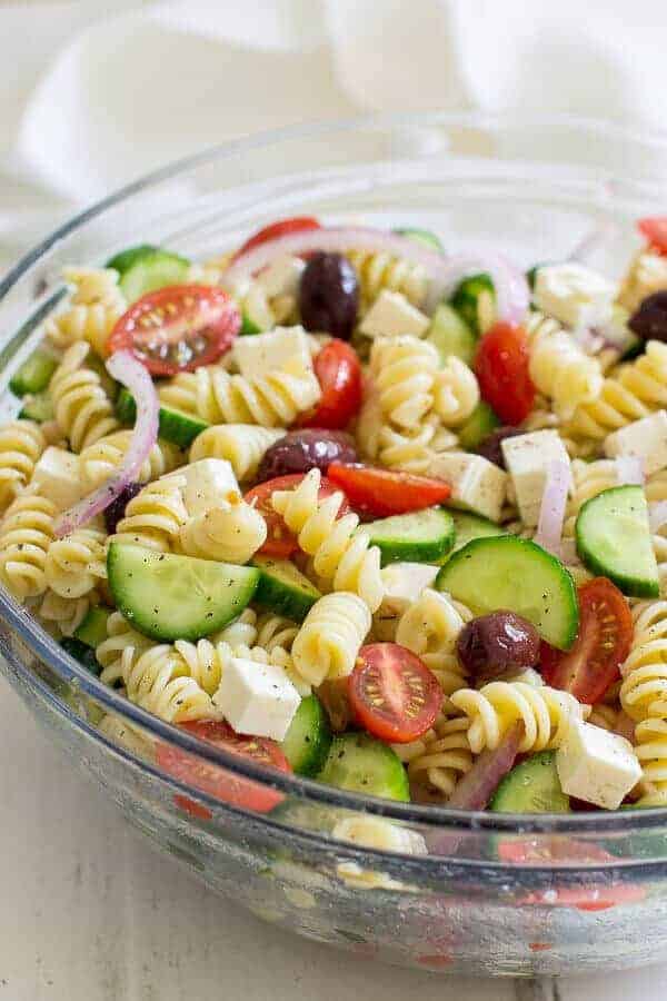 A Greek pasta salad and a glass dish