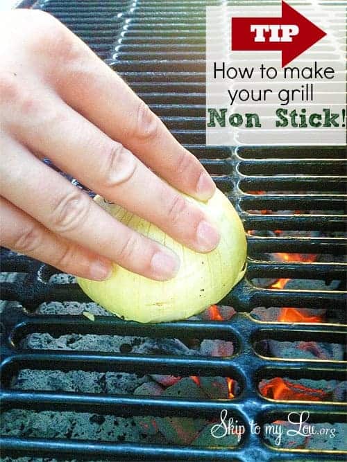A close up of a hand with an onion on a grill