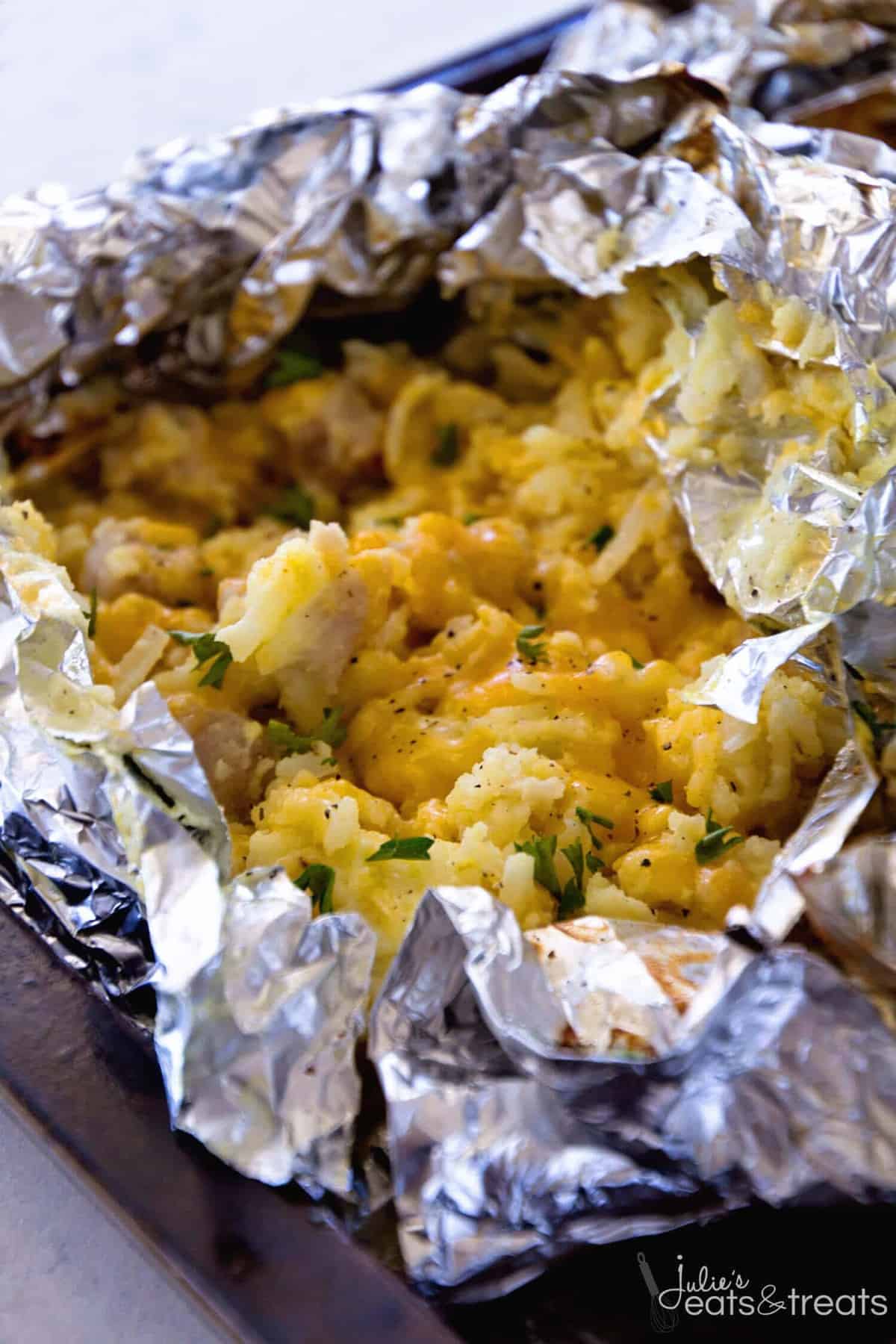 A close up of a foil packet with egg bake breakfast in it for camping