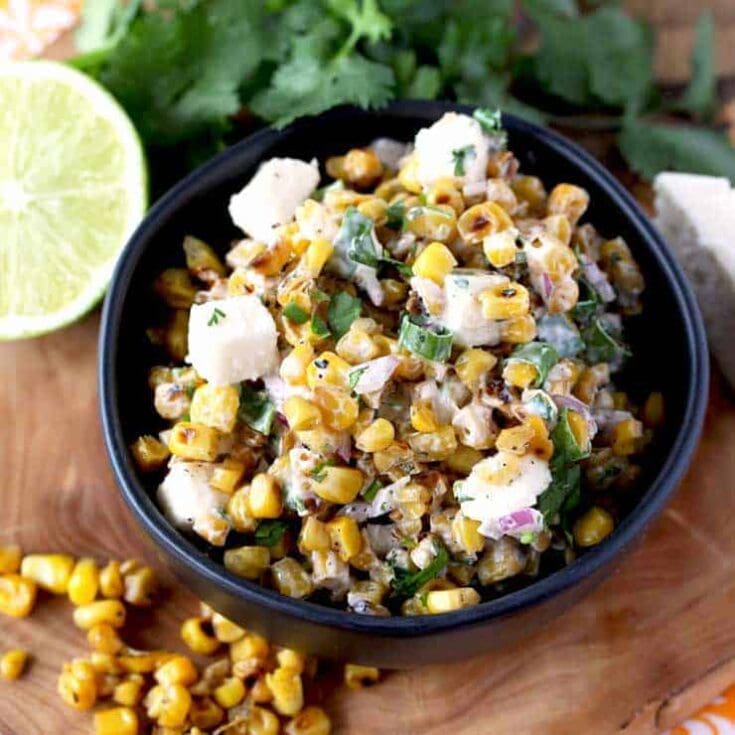 Mexican street corn salad in a black bowl