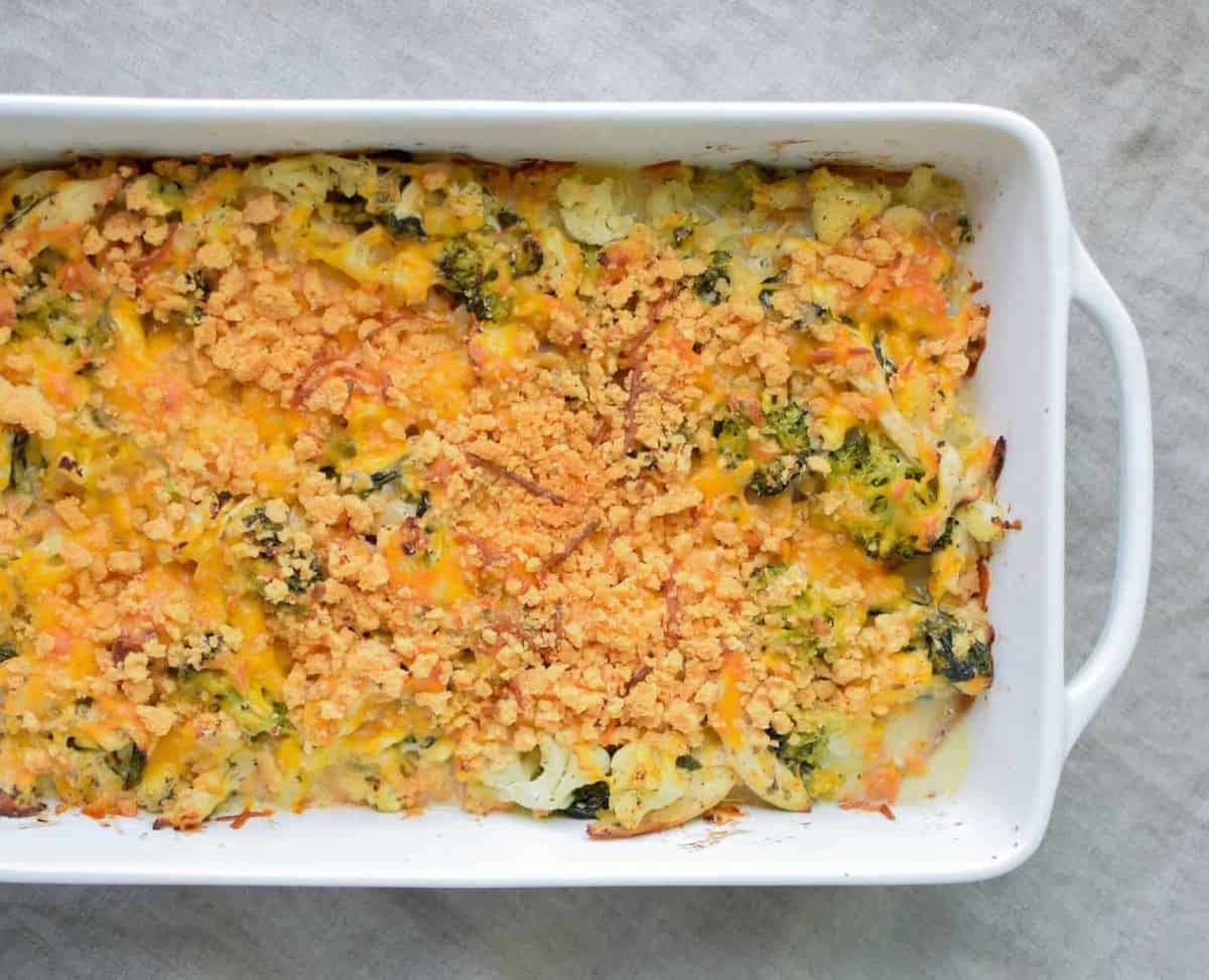 A veggie loaded rotisserie chicken casserole and a white casserole dish