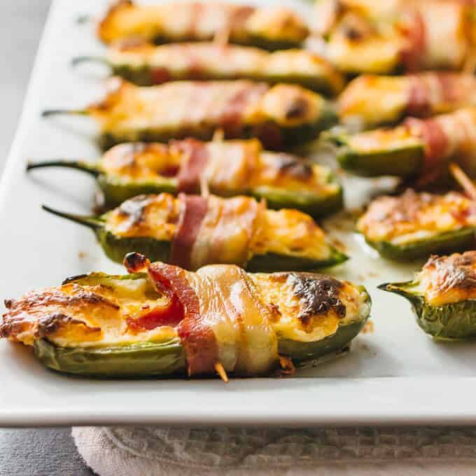 Bacon wrapped jalapeño poppers on a white plate