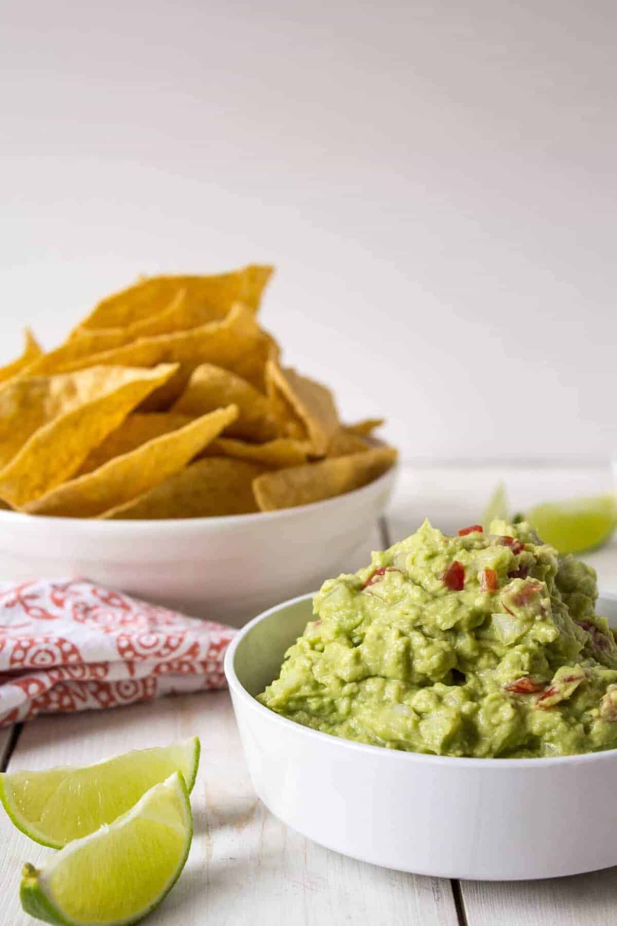 A bowl of guacamole with tortilla chips