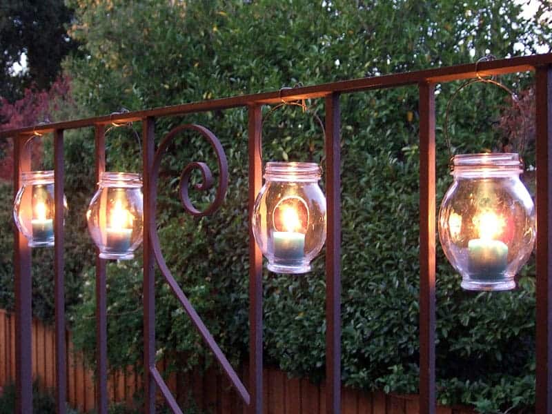 DIY porch lanterns hanging from a porch