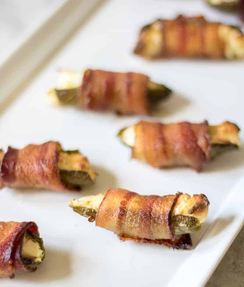 Bacon wrapped grilled jalapeño poppers and a plate