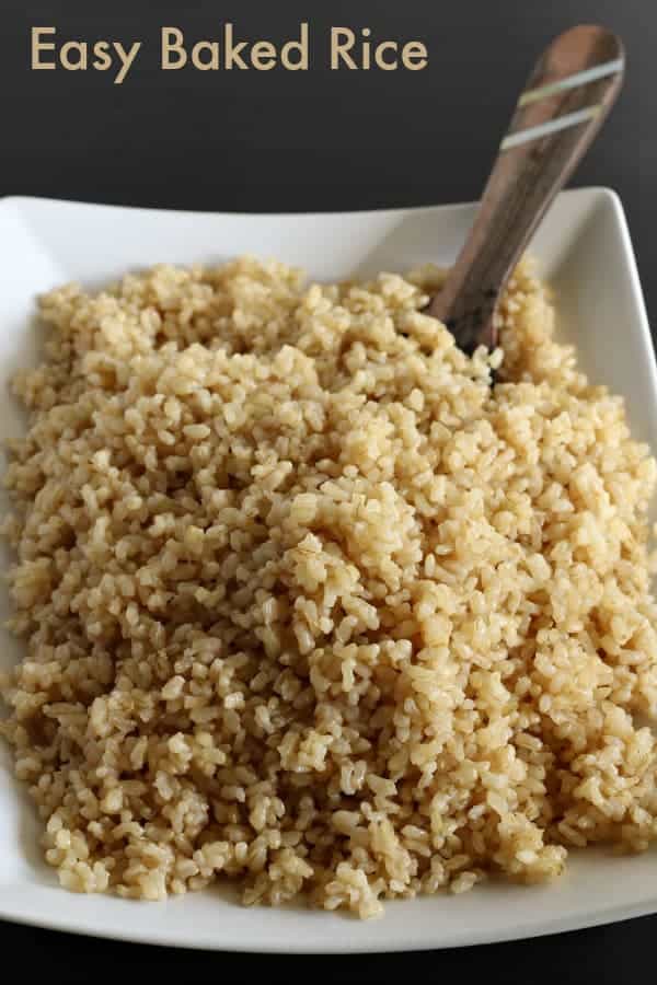 Brown rice in a white dish with a spoon