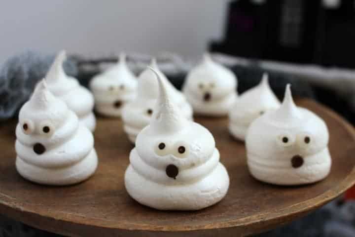 Meringue ghosts on a wood tray