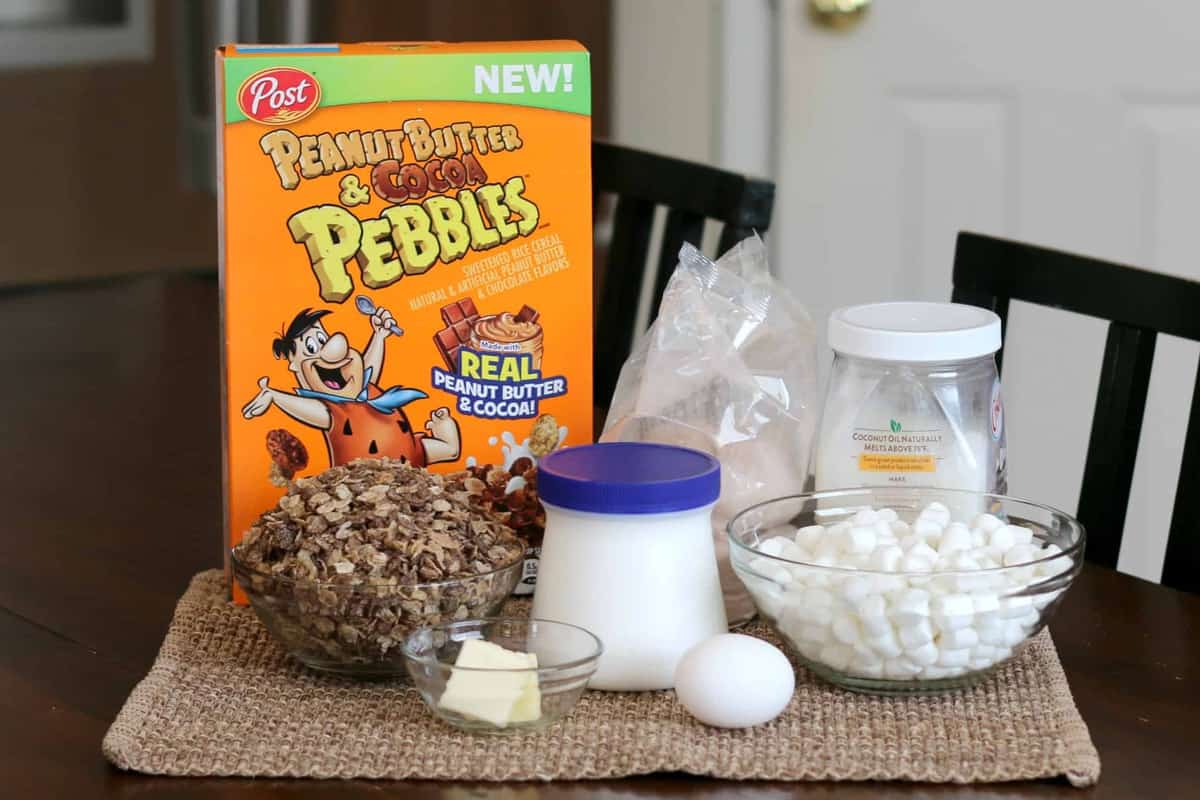 A box of peanut butter and cocoa pebbles on a table with other ingredients