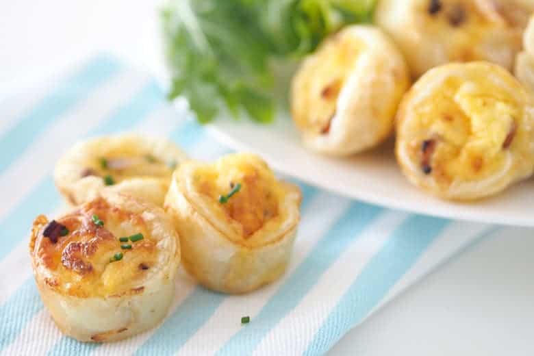 Cheese and bacon mini quiche and a striped towel
