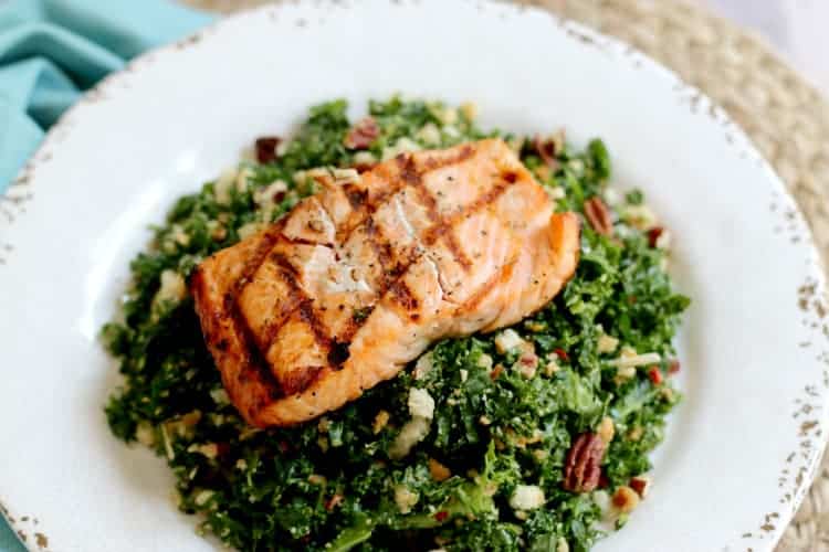 grilled salmon kale salad on a plate. 