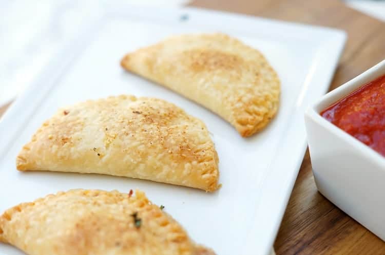 Pizza Empanadas on a plate with marinara dip