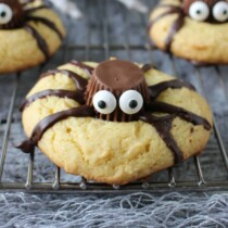a cookie made into a spider with chocolate and candy eyes
