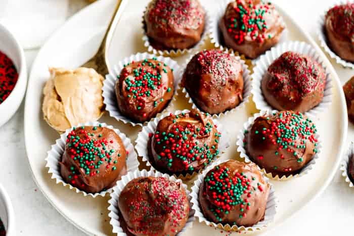 No Bake Peanut Butter Balls with sprinkles on a white plate.