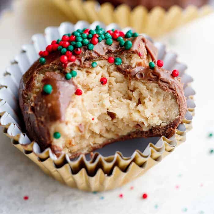 No bake peanut butter ball with a bite taken out and sprinkles on top.
