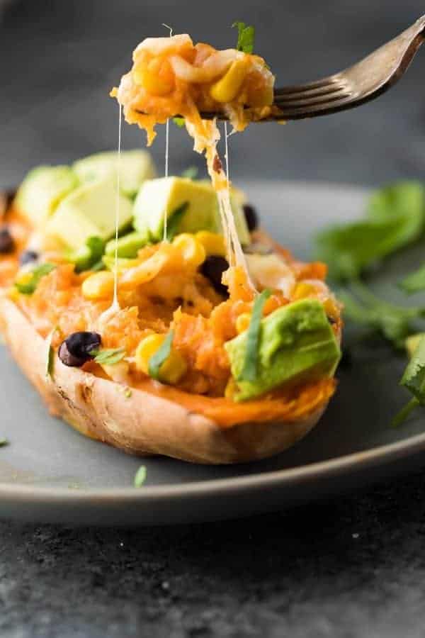 Sweet potatoes stuffed with enchiladas stuffing on a plate