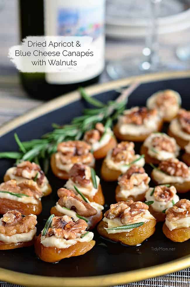 Dried apricot and blue canapes on a black dish