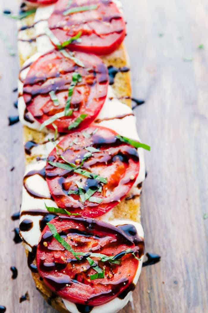 Caprese garlic bread and a wood cutting board