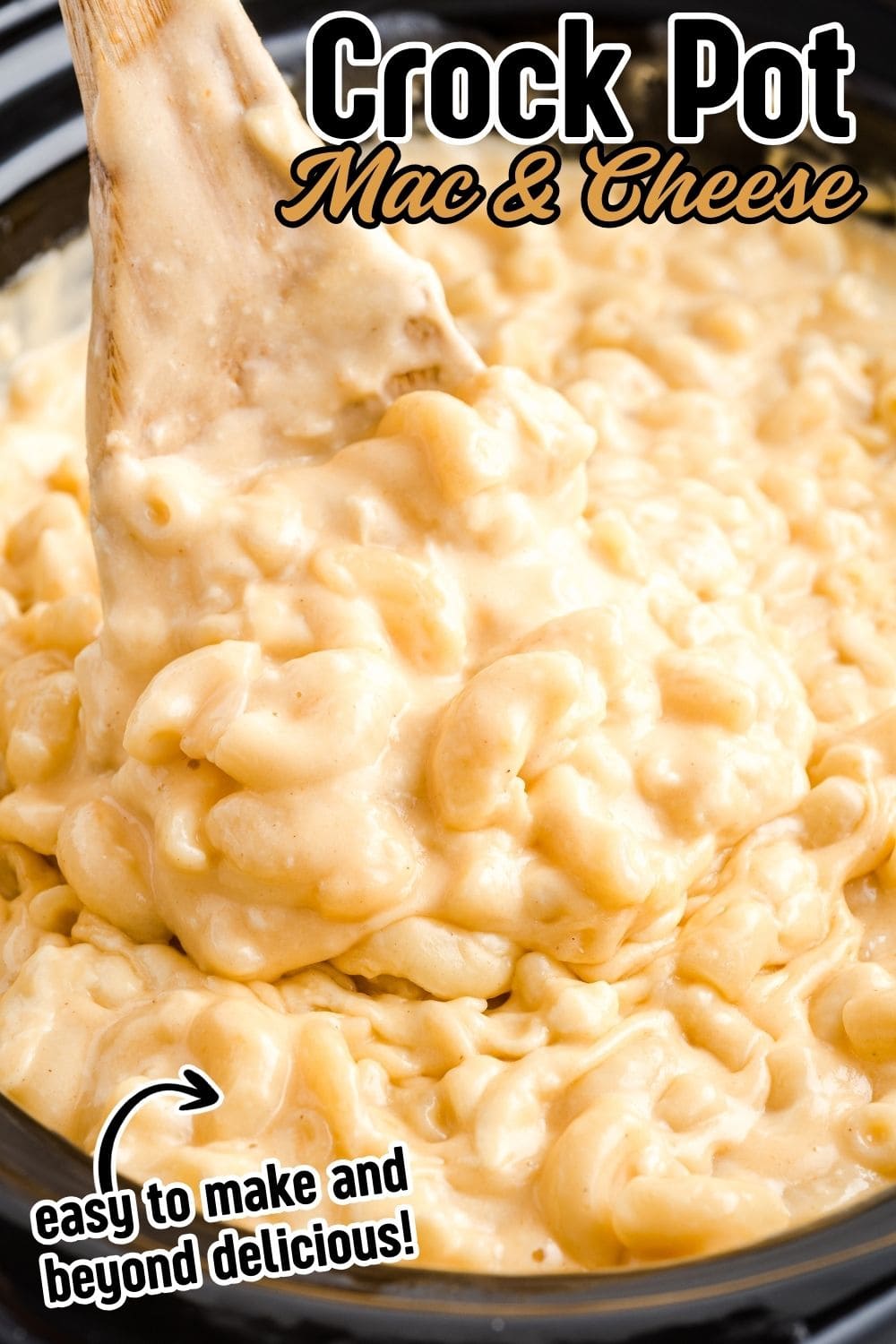 A wooden spoon digging into creamy Crockpot Mac and Cheese in crockpot