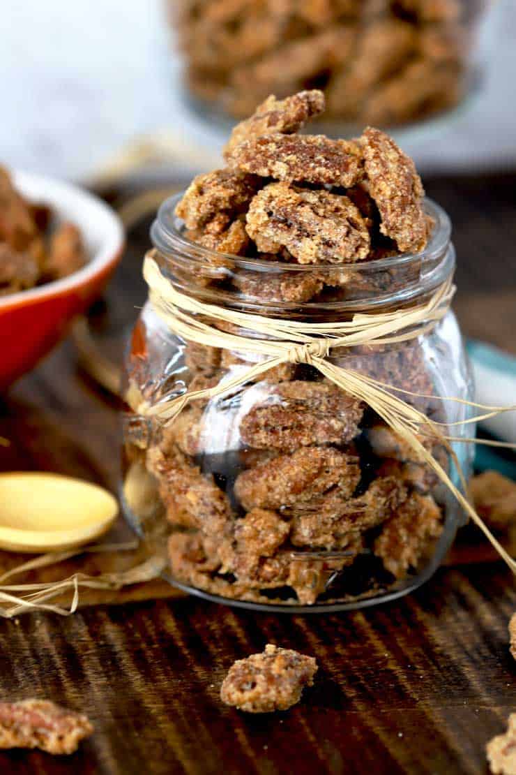 Candied pecans in a glass jar.