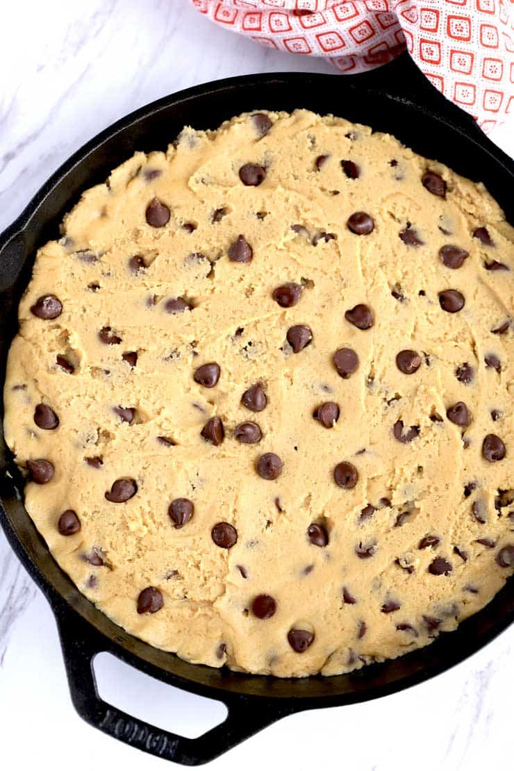 Cookie dough pressed into a skillet.