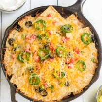 Campfire Nachos with cheese olives and peppers