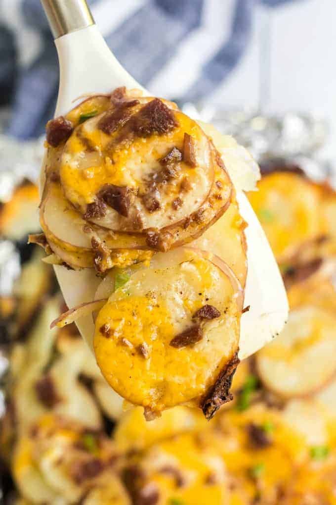 Grilled Potatoes on spoon with cheese and bacon