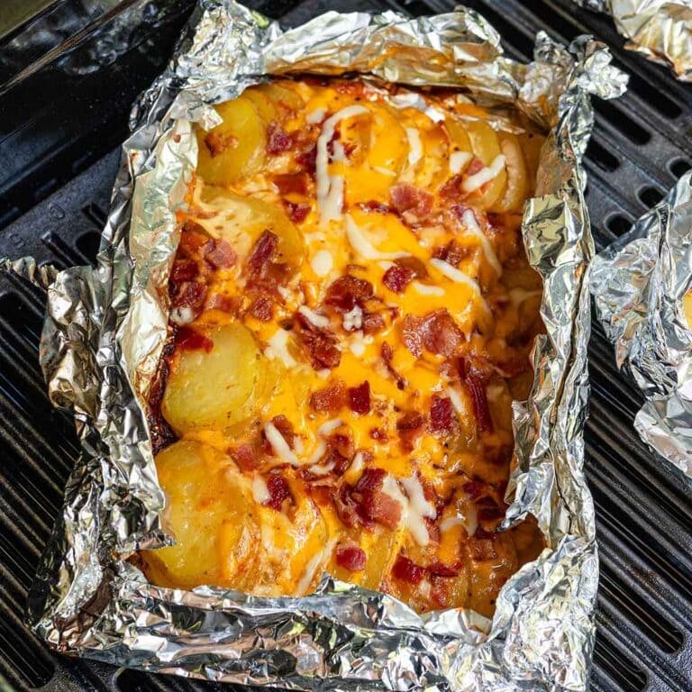 campfire potatoes in a foil on top grill.