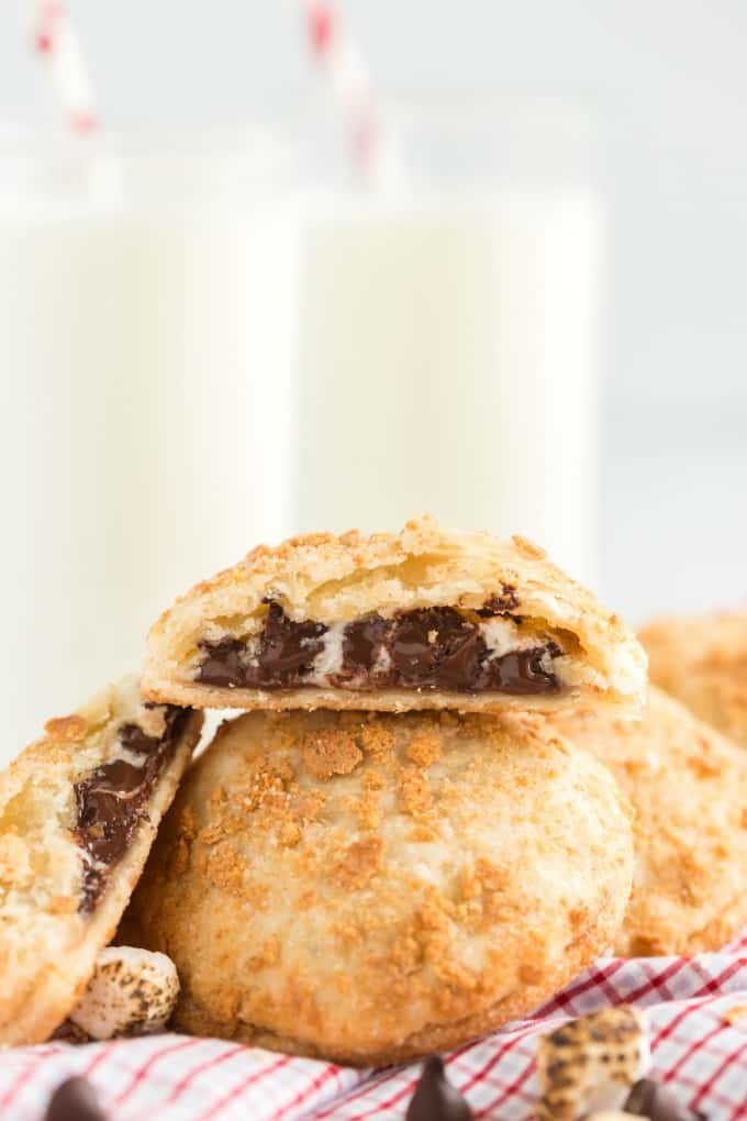 s'mores hand pies broken open in front of a glass of milk