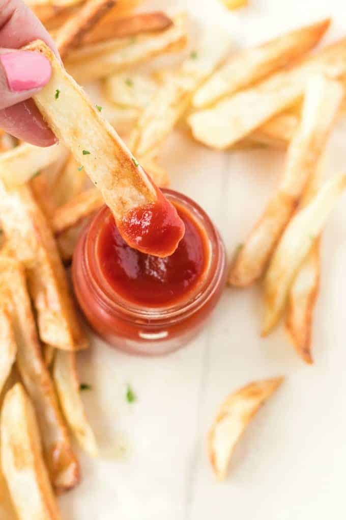 French fries dipped in ketchup