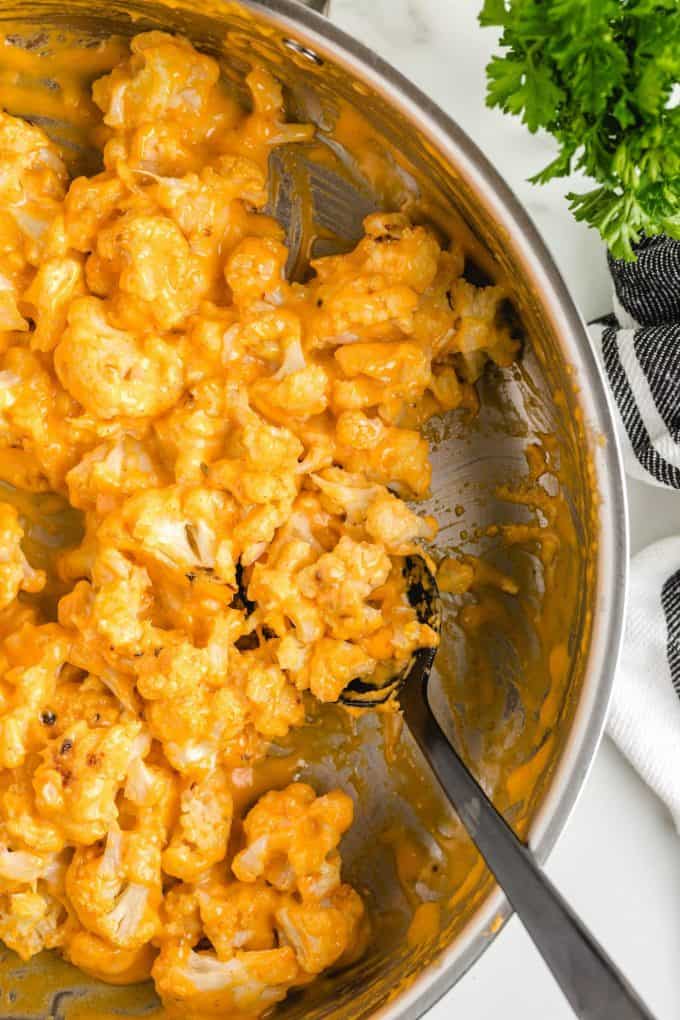 cauliflower mixed with cheese in a pan