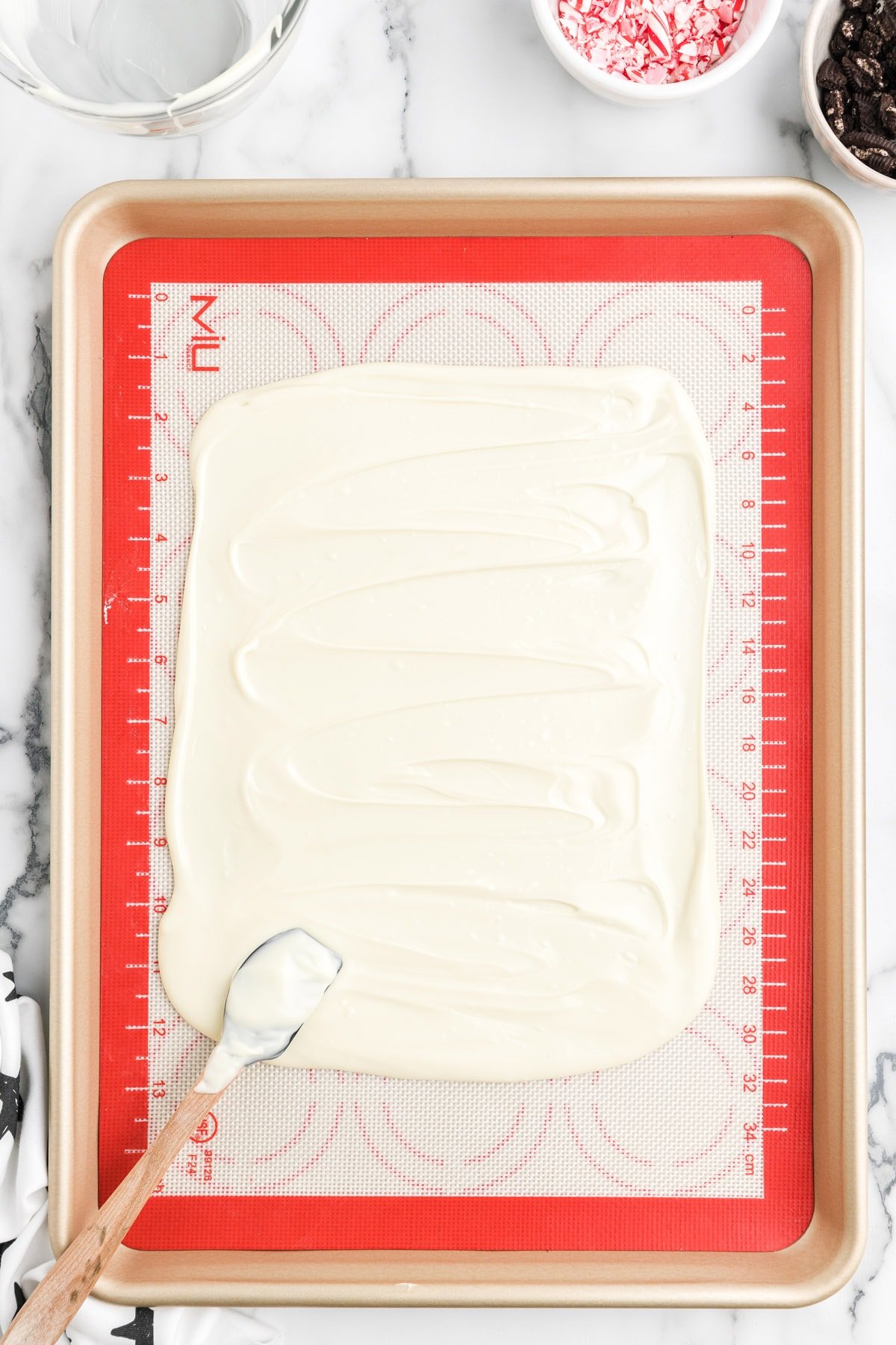 Pour the melted white chocolate onto the prepared sheet