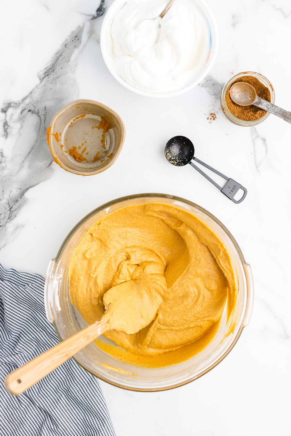 Add the pumpkin puree, brown sugar and pumpkin pie spice to the cream cheese mixture and gently fold together until combined and solid in color