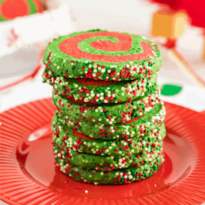 Christmas Pinwheel Cookies stacked on a red plate