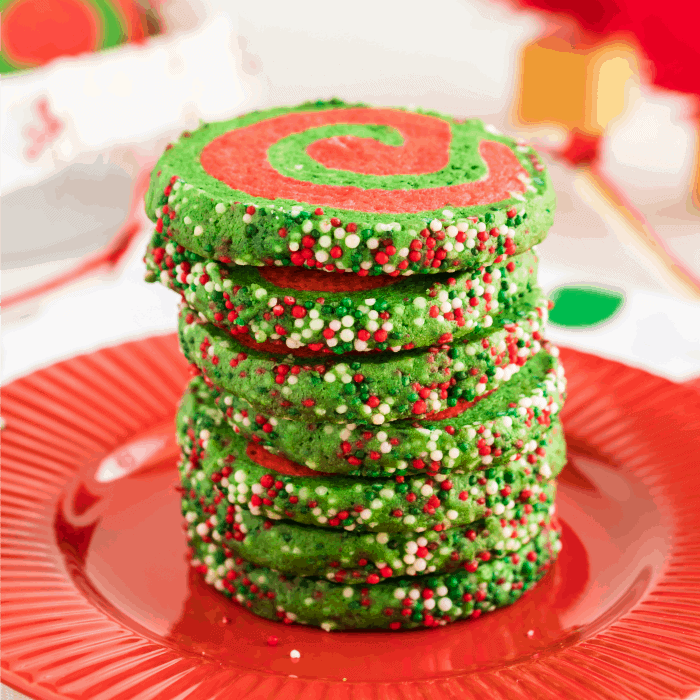 Christmas Pinwheel Cookies stacked on a red plate
